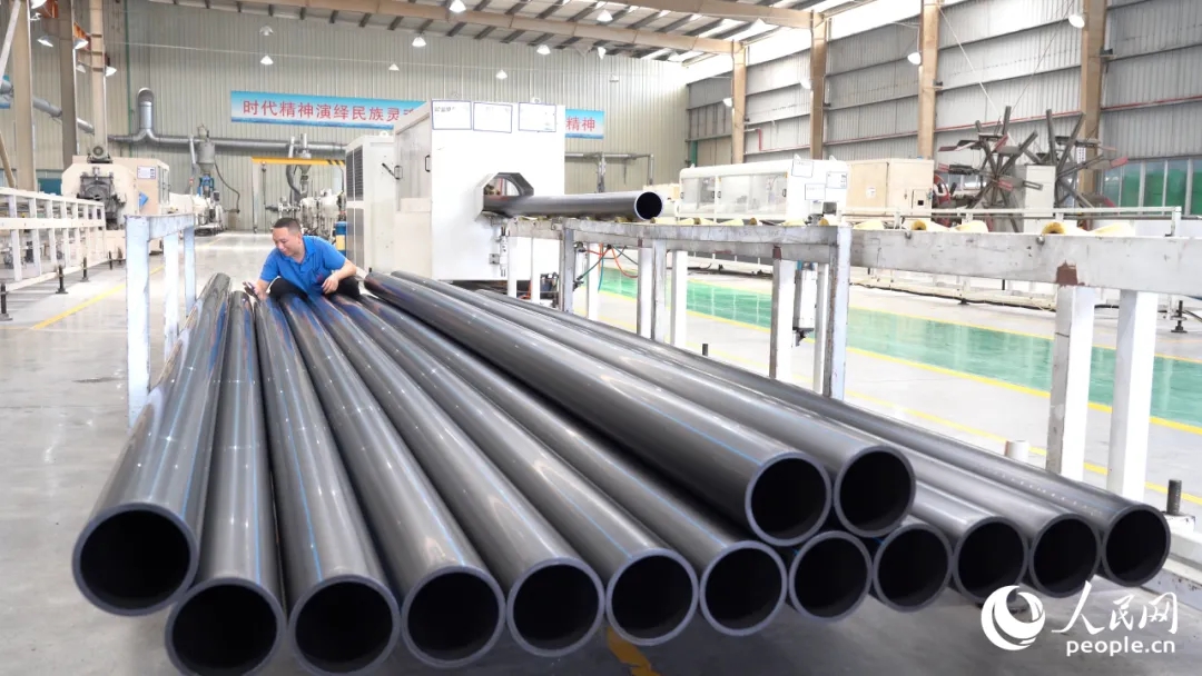 藍(lán)深環(huán)保車間里，工人對生產(chǎn)出的管材進(jìn)行檢測。