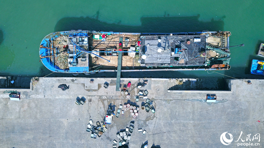 5.在澳角村，一艘漁船停在岸邊卸下漁貨。人民網(wǎng) 李昌乾攝