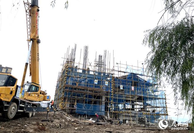 細雨綿綿，工地上一派忙碌景象。人民網(wǎng)記者 陳藍燕攝