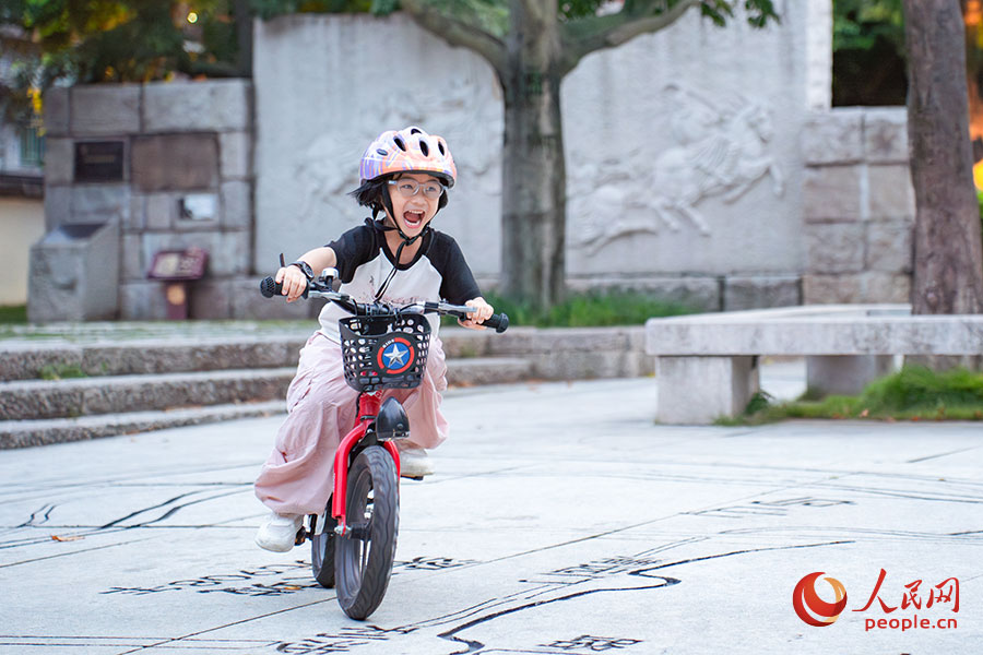 7月15日，在福建福州的冶山春秋園，一位小女孩在練習(xí)騎自行車。實(shí)習(xí)生 魏建燁攝